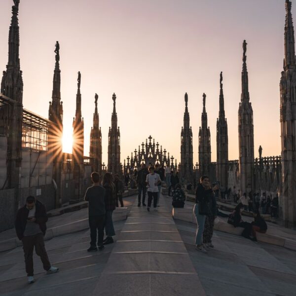 Tourists enjoy a sunset view from the Terrazza del Duomo in Milan, Italy.
