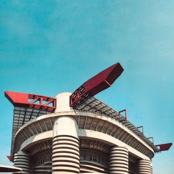 San Siro Stadium Dynamic low angle view of the iconic San Siro Stadium in Milan, Italy, against a blue sky.