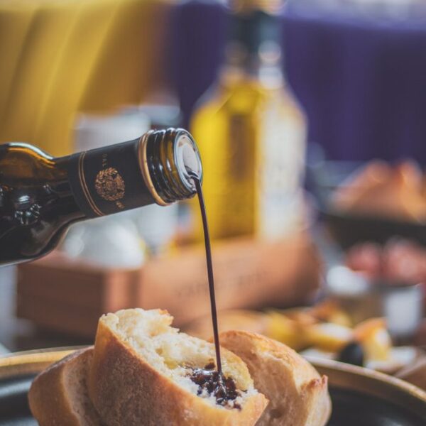 Balsamic Vinegar Close-up of balsamic vinegar being poured on bread with a blurred background.