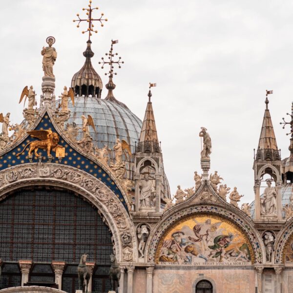 St. Mark’s Balisica Detailed view of St. Mark's Basilica facade in Venice, showcasing intricate architecture and religious artwork.