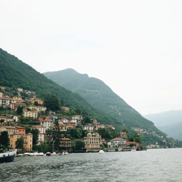 Lake Como Picturesque view of Lake Como with hillside houses and lush green mountains in Lombardy, Italy.