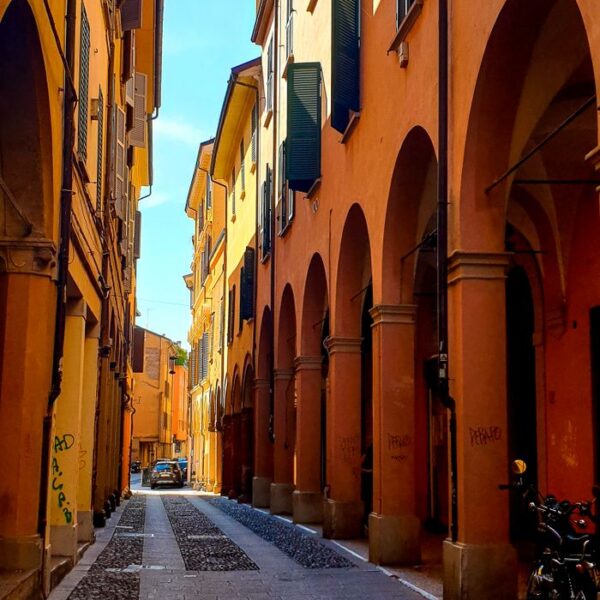 Bologna Beautiful arched walkway along a cobblestone street in Bologna, Italy.