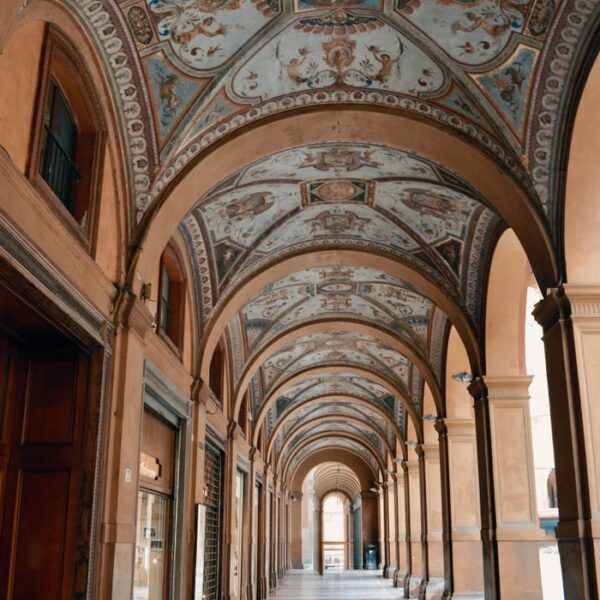 Bologna Elegant arched walkway with ornate decorations in Bologna, Italy.