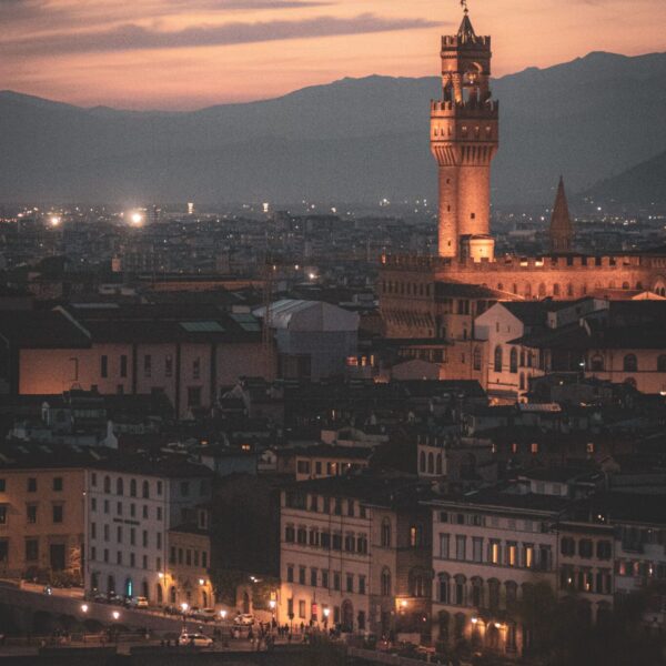 Scenic view of Palazzo Vecchio at sunset in Florence, Tuscany, featuring a vibrant cityscape.