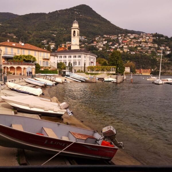 Lake Como Peaceful harbor scene at Lake Como with boats and scenic hillsides.