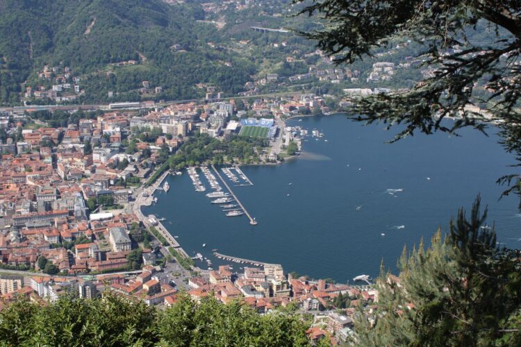A stunning aerial view of Lake Como with surrounding cityscape and marina in Lombardia, Italy.