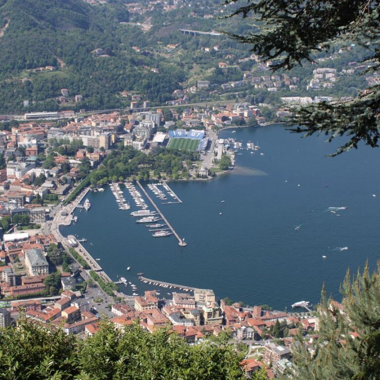 A stunning aerial view of Lake Como with surrounding cityscape and marina in Lombardia, Italy.