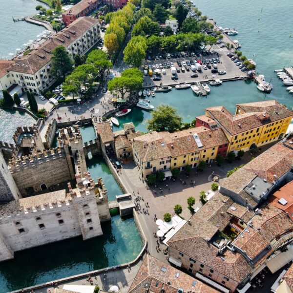 Sirmione Stunning overhead view of Sirmione, Italy, featuring the historic castle and vibrant town.