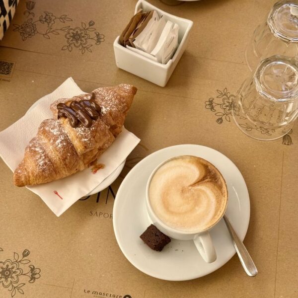 Italian Breakfast Cozy morning setup with cappuccino and chocolate croissant, perfect start to the day.
